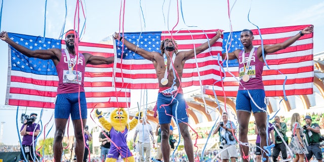 Erriyon Knighton (R), bronze winner, Noah Lyles (M), gold winner, and Kenneth Bednarek, silver medalist, from the USA cheer after the race July 21, 2022 in Eugene, Oregon.