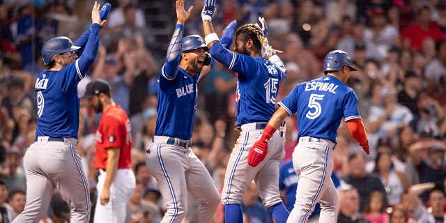 Raimel Tapia #15 of the Toronto Blue Jays reacts after hitting an inside-the-park grand slam during the third inning of a game against the Boston Red Sox on July 22, 2022 at Fenway Park in Boston, Massachusetts. 