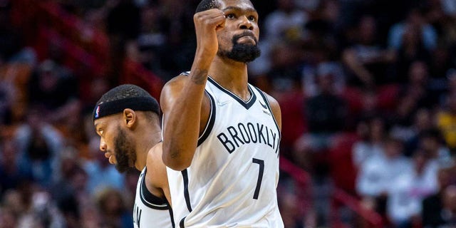 Brooklyn Nets forward Kevin Durant reacts after scoring over Heat center Bam Adebayo during at FTX Arena in Miami on March 26, 2022.