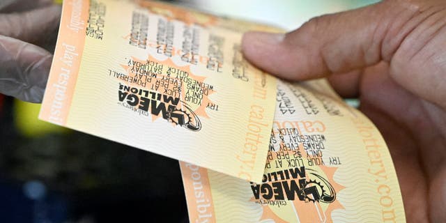A customer at a 7-Eleven on Chino Hills Parkway in Chino Hills receives their lottery tickets on Wednesday, July 27, 2022.