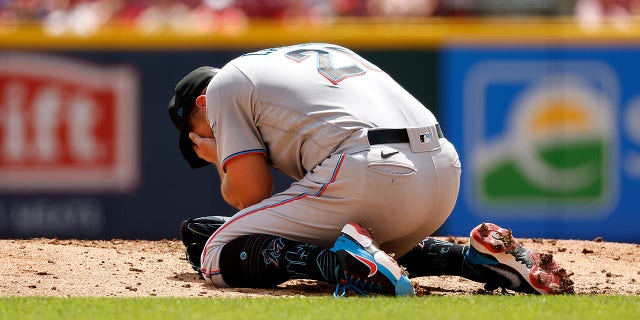 Daniel Castano of the Miami Marlins grabs his face after being hit by a line drive while pitching in the first inning against the Cincinnati Reds at Great American Ball Park, July 28, 2022, in Cincinnati, Ohio.