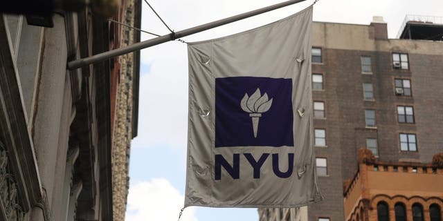 The New York University (NYU) flag will fly outside the Covid-19 test tent outside NYU Business School in New York City on August 25, 2020.