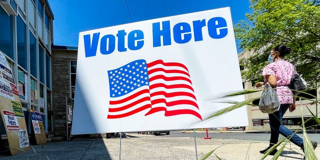 A "Vote Here" sign outside the polling place setup in the 3rd and Court Fire Station in Reading, Pennsylvania, Tuesday morning May 18, 2021.