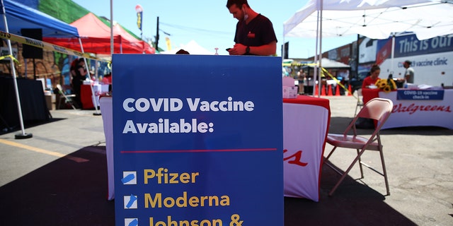 LOS ANGELES, CALIFORNIA - JUNE 25: A sign displays the types of COVID-19 vaccination doses available at a Walgreens mobile bus clinic on June 25, 2021 in Los Angeles, California. 