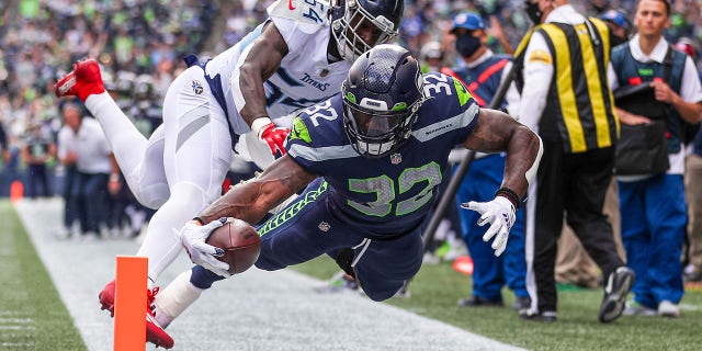 Rashaan Evans #54 of the Tennessee Titans forces Chris Carson #32 of the Seattle Seahawks shy of a touchdown during the second quarter at Lumen Field on Sept. 19, 2021 in Seattle, Washington.