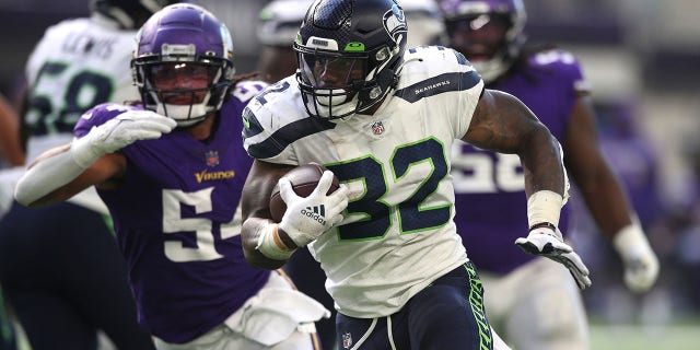Chris Carson #32 of the Seattle Seahawks runs the ball for a touchdown during the second quarter in the game against the Minnesota Vikings at U.S. Bank Stadium on Sept. 26, 2021 in Minneapolis, Minnesota.