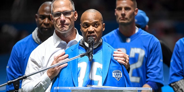 Chris Spielman (left) hugs former Detroit Lions players William White during the Pride of the Lions celebration at halftime against the Philadelphia Eagles at Ford Field in Detroit. 31st, 2021.