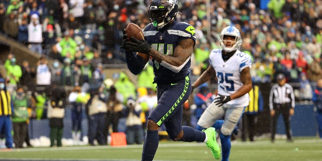 DK Metcalf of the Seattle Seahawks catches the ball for a touchdown during the second quarter of an NFL game against the Detroit Lions at Lumen Field in Seattle, Washington, on Jan. 2, 2022.