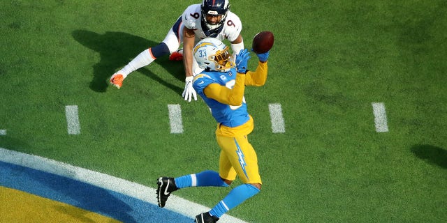Derwin James of the Los Angeles Chargers stops the pass intended for Kendall Hinton of the Denver Broncos at SoFi Stadium on Jan. 2, 2022, in Inglewood, California.