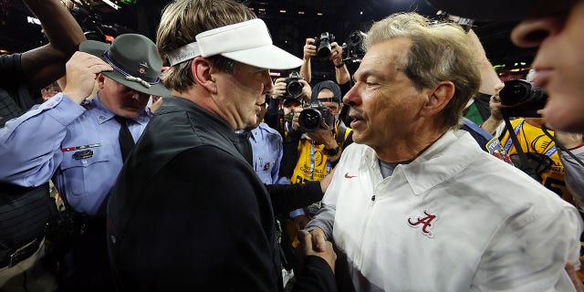 Head Coach Nick Saban of the Alabama Crimson Tide and Head Coach Kirby Smart of the Georgia Bulldogs shake hands after the Georgia Bulldogs defeated the Alabama Crimson Tide 33-18 in the 2022 CFP National Championship Game at Lucas Oil Stadium on January 10, 2022 in Indianapolis, Indiana.