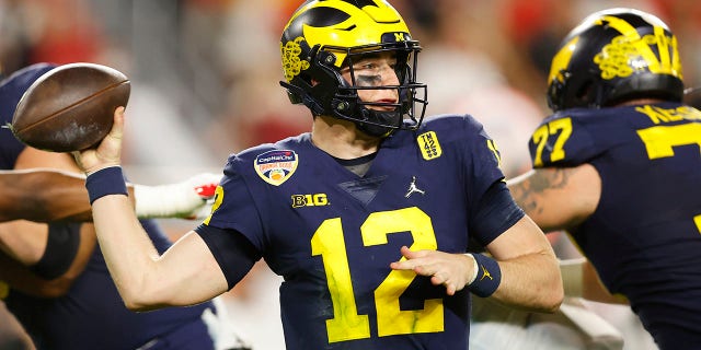 Cade McNamara, #12 of the Michigan Wolverines, looks to pass against the Georgia Bulldogs in the Capital One Orange Bowl for the College Football Playoff semifinal game at Hard Rock Stadium on December 31, 2021 in Miami Gardens, Florida.