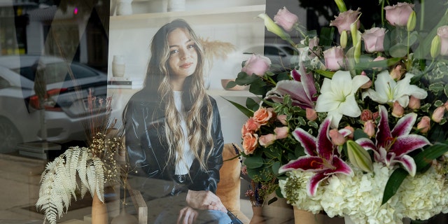 Flowers are displayed outside the Crofthouse furniture store in Los Angeles in memory of murdered graduate student Briana Kupfer.