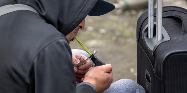 A homeless man, 24, smokes fentanyl on March 12, 2022, in Seattle.