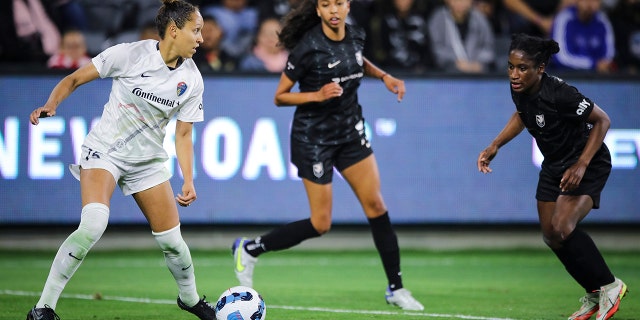 Jaelene Daniels of the North Carolina Courage, left, looks to pass the ball against Angel City FC at Banc of California Stadium April 29, 2022, in Los Angeles. 