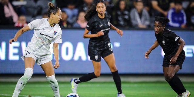 Jaelene Daniels of the North Carolina Courage, left, looks to pass the ball against Angel City FC at Banc of California Stadium April 29, 2022, in Los Angeles. 