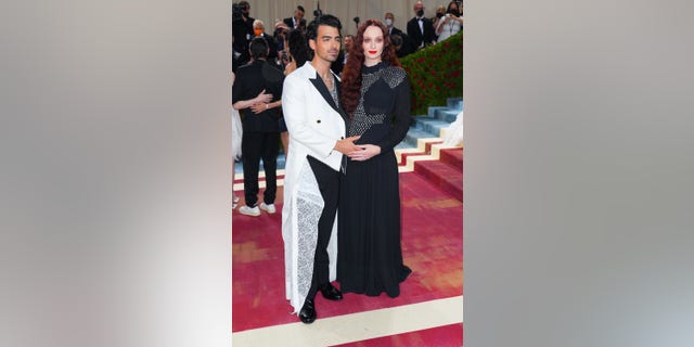 Turner and Jonas cradled her baby bump on the red carpet during the 2022 Met Gala in New York City.