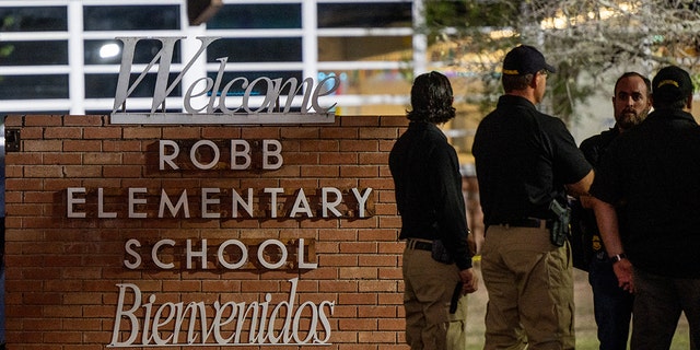Law enforcement officers speak together outside of Robb Elementary School following the mass shooting at Robb Elementary School on May 24, 2022 in Uvalde, Texas. According to reports, 19 students and 2 adults were killed, with the gunman fatally shot by law enforcement. 