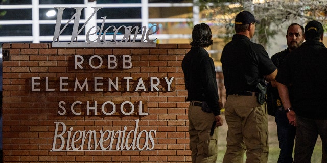 Law enforcement officers gather outside Robb Elementary School following the mass shooting there on May 24, 2022, in Uvalde, Texas. According to reports, 19 students and two adults were killed, with the gunman fatally shot by law enforcement.