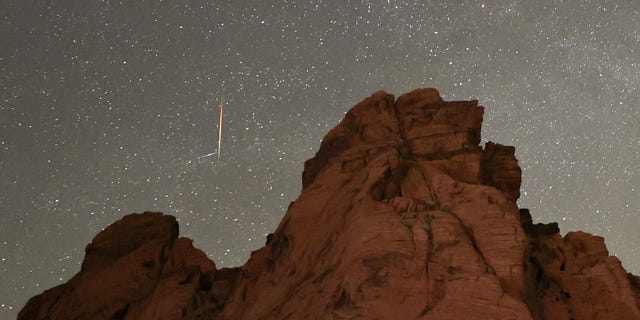 A meteor streaks above sandstone formations as the Earth passes through the debris trails of a broken comet called 73P/Schwassmann-Wachmann, or SW3, producing a never-before-seen meteor shower called the Tau Herculids on May 30, 2022, in the Valley of Fire State Park, Nevada.