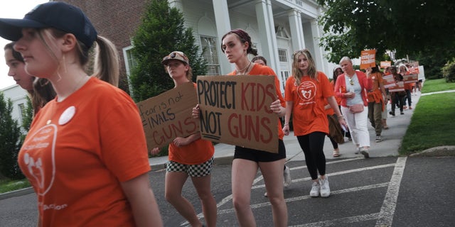 People attend a rally and march for National Gun Violence Awareness Day on June 03, 2022, in Newtown, Connecticut. Across the nation people are wearing orange and joining rallies as they demand change to America's gun laws. 