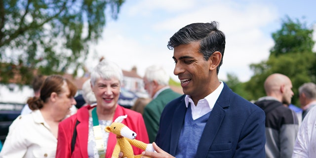 GREAT AYTON, ENGLAND - JUNE 04: Rishi Sunak MP, Chancellor of the Exchequer tours charity stalls on the village green during the Queen’s Platinum Jubilee celebrations at the Great Ayton Village Fete on June 04, 2022 in Great Ayton, England. The Platinum Jubilee of Elizabeth II is being celebrated from June 2 to June 5, 2022, in the UK and Commonwealth to mark the 70th anniversary of the accession of Queen Elizabeth II on 6 February 1952. (Photo by Ian Forsyth/Getty Images)