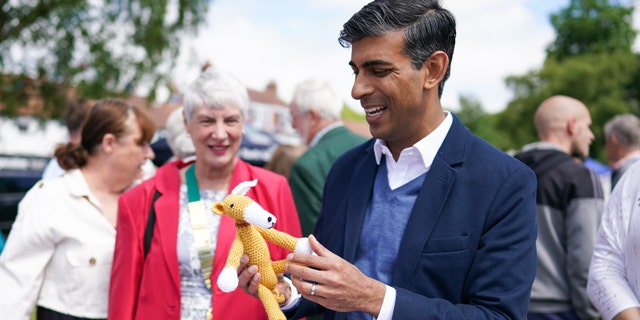 GREAT AYTON, ENGLAND - JUNE 04: Rishi Sunak MP, Chancellor of the Exchequer tours charity stalls on the village green during the Queen’s Platinum Jubilee celebrations at the Great Ayton Village Fete on June 04, 2022 in Great Ayton, England. The Platinum Jubilee of Elizabeth II is being celebrated from June 2 to June 5, 2022, in the UK and Commonwealth to mark the 70th anniversary of the accession of Queen Elizabeth II on 6 February 1952. (Photo by Ian Forsyth/Getty Images)