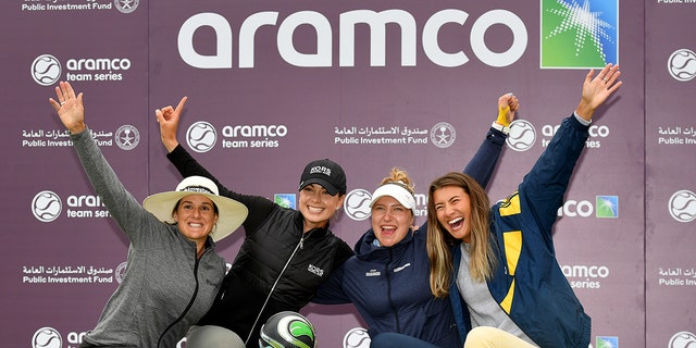 From left, Mia Baker of the United Kingdom, Nicole Garcia of South Africa, Madeleine Stavner of Norway, and Kelly Whaley of the United States at the Aramco Team Series London Day 3 team event at the Centurion Club in St Albans. After winning, celebrate with a trophy. United Kingdom, June 18, 2022.
