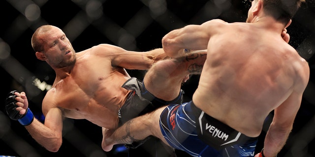 Donald Cerrone (L) exchanges strikes with Jim Miller during their welterweight bout at UFC 276 at T-Mobile Arena on July 02, 2022 in Las Vegas, Nevada.  (Photo by Carmen Mandato/Getty Images)