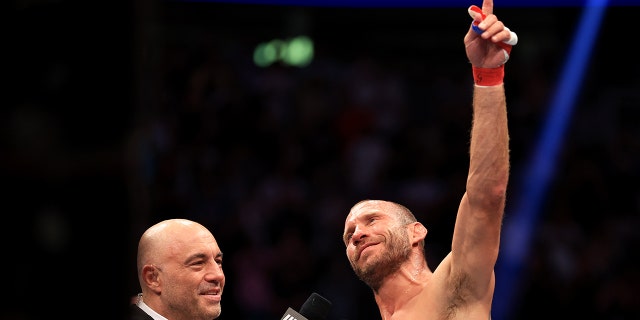 Donald Cerrone (R) speaks with Joe Rogan as he announces his retirement after his welterweight bout against Jim Miller during UFC 276 at T-Mobile Arena on July 02, 2022 in Las Vegas, Nevada. (Photo by Carmen Mandato/Getty Images)