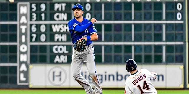 Whit Merrifield #15 of the Kansas City Royals turns a double play against the Houston Astros at Minute Maid Park on July 07, 2022 in Houston, Texas.
