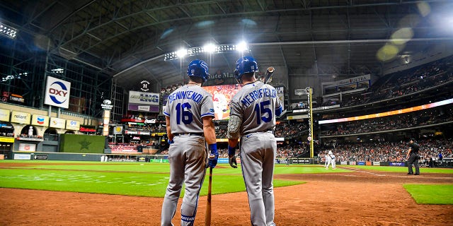 Andrew Benintendi #16 of the Kansas City Royals talks to Whit Merrifield #15 of the Kansas City Royals during the game against the Houston Astros at Minute Maid Park on July 06, 2022 in Houston, Texas.