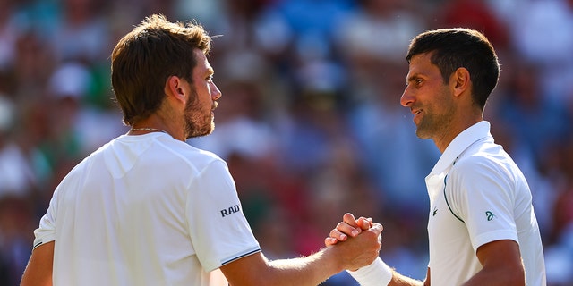 Novak Djokovic de Serbia, a la derecha, es felicitado por Cameron Norrie de Gran Bretaña después de la victoria de Djokovic en las semifinales de singles masculinos de Wimbledon 2022 en el All England Lawn Tennis and Croquet Club el 8 de julio de 2022 en Londres.