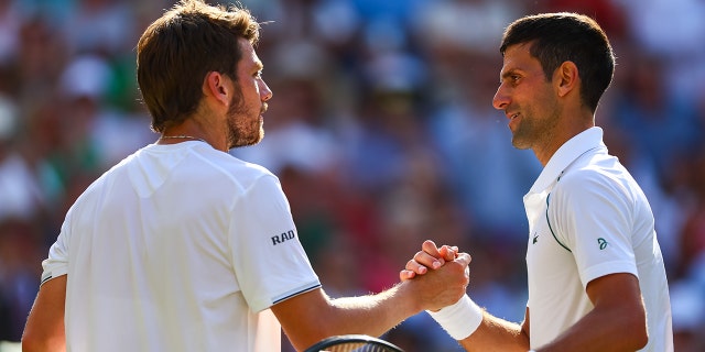 Novak Djokovic of Serbia, right, is congratulated by Cameron Norrie of Great Britain after Djokovic's victory in the men's singles semifinals of Wimbledon 2022 at the All England Lawn Tennis and Croquet Club July 8, 2022, in London.