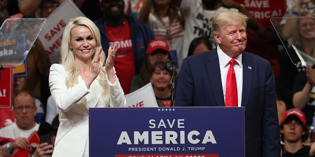 Republican US Senate candidate Kelly Tshibaka (L) stands on stage with former US President Donald Trump (R) during a "save america" rally at the Alaska Airlines Center on July 09, 2022 in Anchorage, Alaska. 
