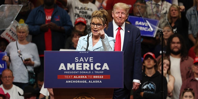 Republican U.S. House candidate and former Alaska Gov. Sarah Palin speaks as former President Trump looks on during a rally at Alaska Airlines Center on July 09, 2022 in Anchorage, Alaska.