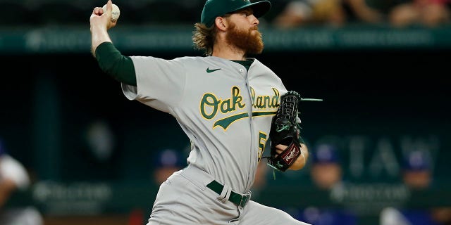 Paul Blackburn #58 of the Oakland Athletics throws a pitch in the first inning against the Texas Rangers at Globe Life Field on July 13, 2022 in Arlington, Texas.