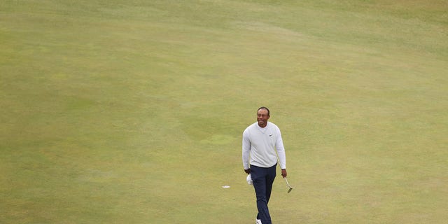 Tiger Woods of the United States acknowledges the crowd on the 18th green during Day Two of The 150th Open at St Andrews Old Course on July 15, 2022 in St Andrews, Scotland. 