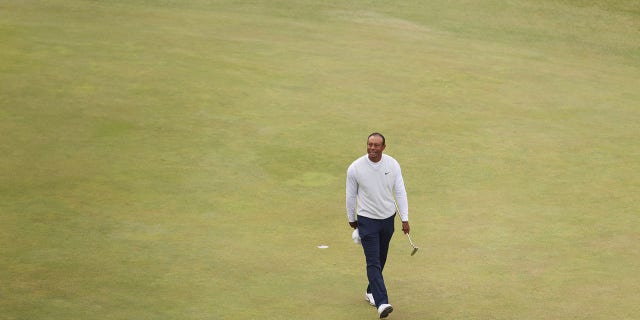 Tiger Woods of the United States acknowledges the crowd on the 18th green during Day Two of The 150th Open at St Andrews Old Course on July 15, 2022 in St Andrews, Scotland.