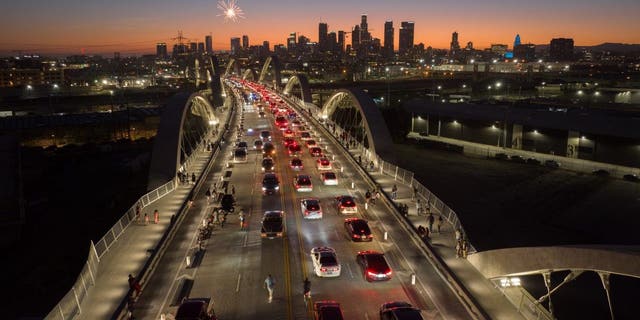 The Sixth Street Bridge is filled with cruising cars as part of a low-rider event in Los Angeles on July 10, 2022.