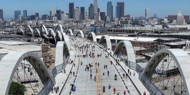 A drone view of the downtown skyline and the Sixth Street Bridge in Los Angeles on July 10, 2022.