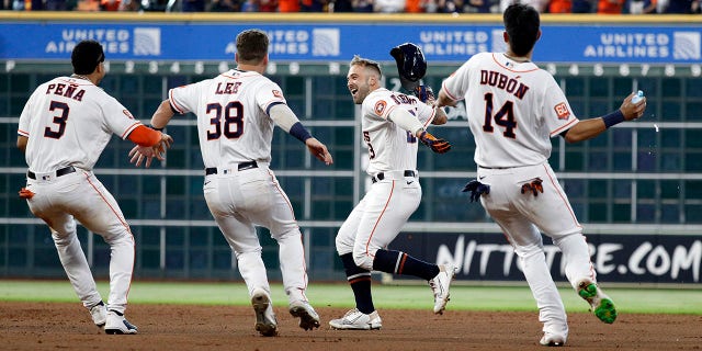 J.J. Matijevic, #13 of the Houston Astros, celebrates with his teammates after hitting a walk-off single against the New York Yankees during game one of a doubleheader at Minute Maid Park on July 21, 2022 in Houston, Texas.