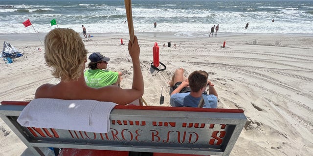 Lifeguards watch bathers on Long Beach July 21, 2022 in Long Beach, New York. A number of beaches have been closed or restricted after a number of sharks were sighted along Long Island this summer. 