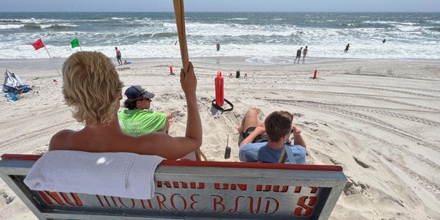 Lifeguards watch bathers on Long Beach July 21, 2022 in Long Beach, New York. A number of beaches have been closed or restricted after a number of sharks were sighted along Long Island this summer.