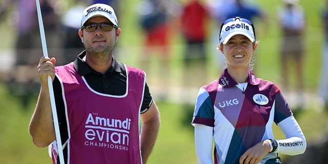Nelly Korda, of The United States, looks on with their caddie on the 18th hole on day two of The Amundi Evian Championship at Evian Resort Golf Club on July 22, 2022 in Evian-les-Bains, France. 