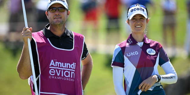 Nelly Korda, of The United States, looks on with their caddie on the 18th hole on day two of The Amundi Evian Championship at Evian Resort Golf Club on July 22, 2022 in Evian-les-Bains, France.