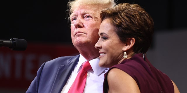 Former President Donald Trump embraces Republican candidate for governor Kari Lake at a rally on July 22, 2022, in Prescott Valley, Arizona.