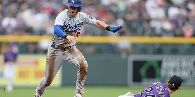 Trea Turner, #6 of the Los Angeles Dodgers, scores on a fielding error against the Colorado Rockies in the first inning at Coors Field on July 28, 2022 in Denver, Colorado.