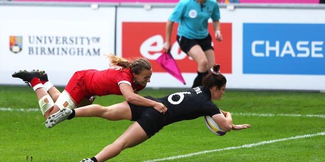 Michaela Blyde of Team New Zealand holds off Krissy Scurfield of Team Canada to score their side's second try during the Women's Rugby Sevens Pool A match between Team New Zealand and Team Canada on day one of the Birmingham 2022 Commonwealth Games at Coventry Stadium.