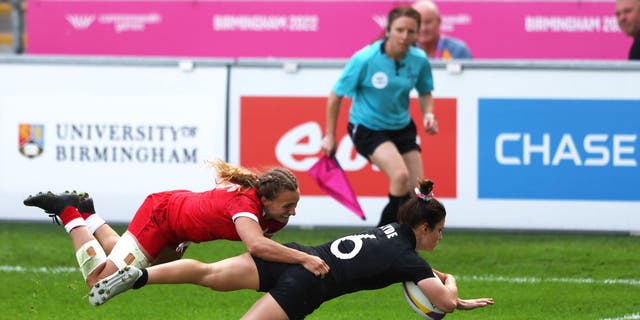Michaela Blyde of Team New Zealand holds off Krissy Scurfield of Team Canada to score their side's second try during the Women's Rugby Sevens Pool A match between Team New Zealand and Team Canada on day one of the Birmingham 2022 Commonwealth Games at Coventry Stadium.