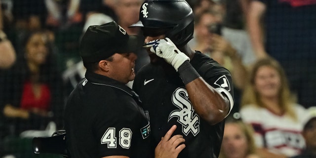 Tim Anderson of the Chicago White Sox, right, is tossed from a game after apparent contact with umpire Nick Mahrley (48) in the seventh inning against the Oakland Athletics at Guaranteed Rate Field July 29, 2022, in Chicago.